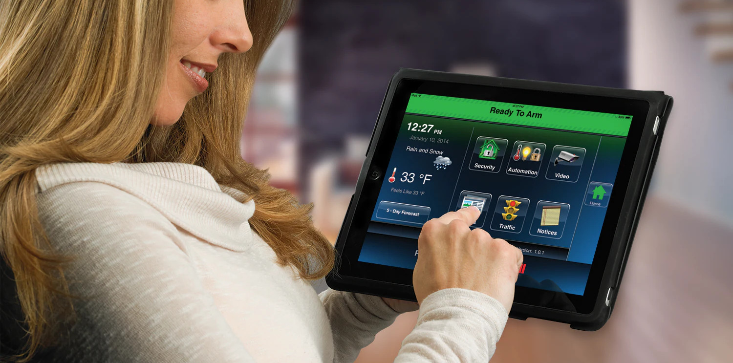 Woman toggling her home alarm from the tablet application.